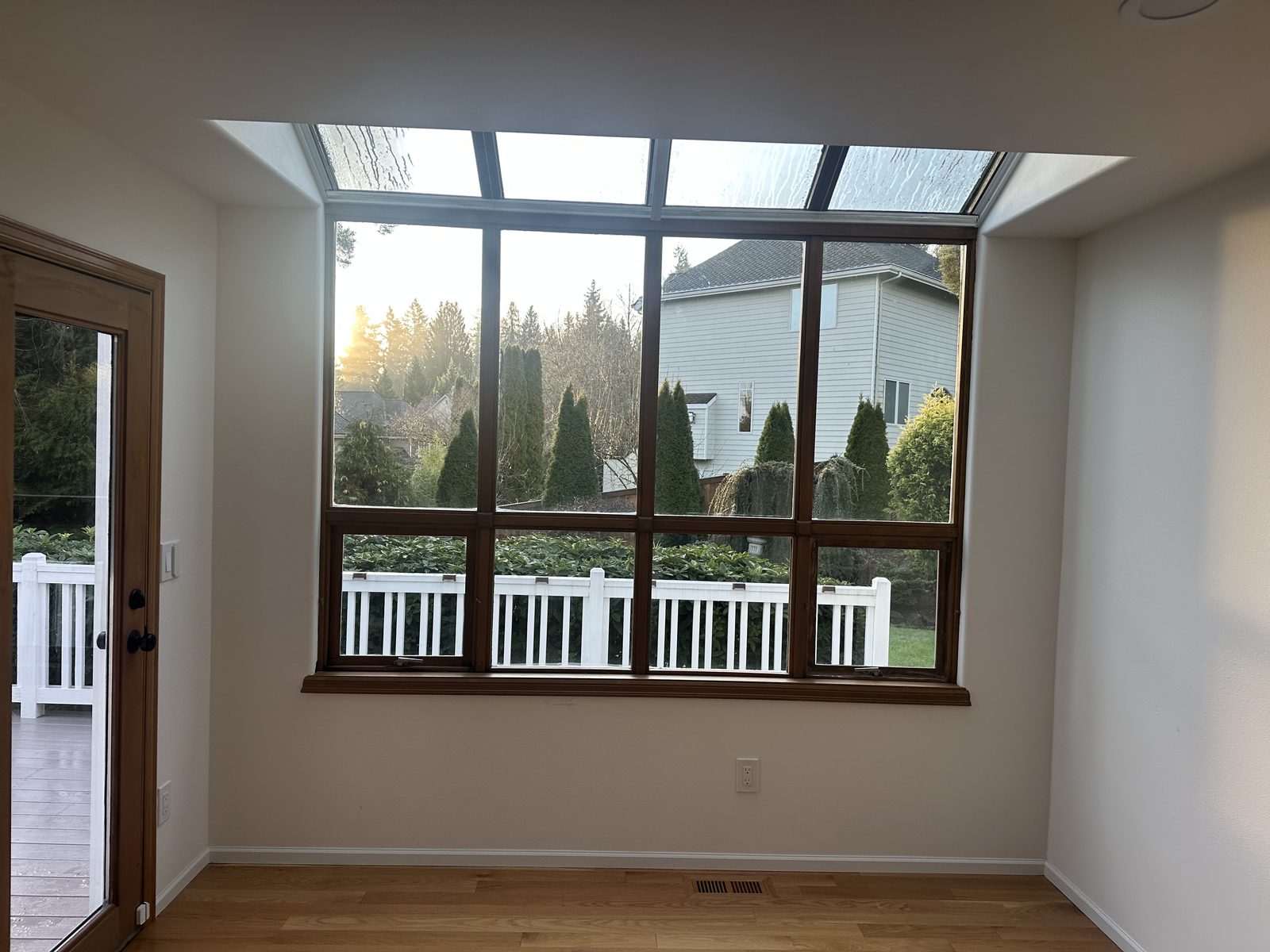 Redmond skywall interior before replacement — dark wood frames with divided grids