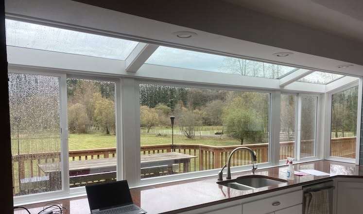 New dual-pane picture windows and a patio slider replacing foggy glass on a Sammamish plateau home